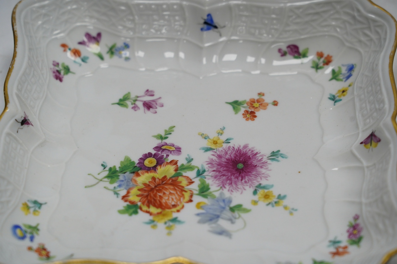 A pair of Meissen square shaped dishes, painted with scattered floral sprigs. Condition - fair to good